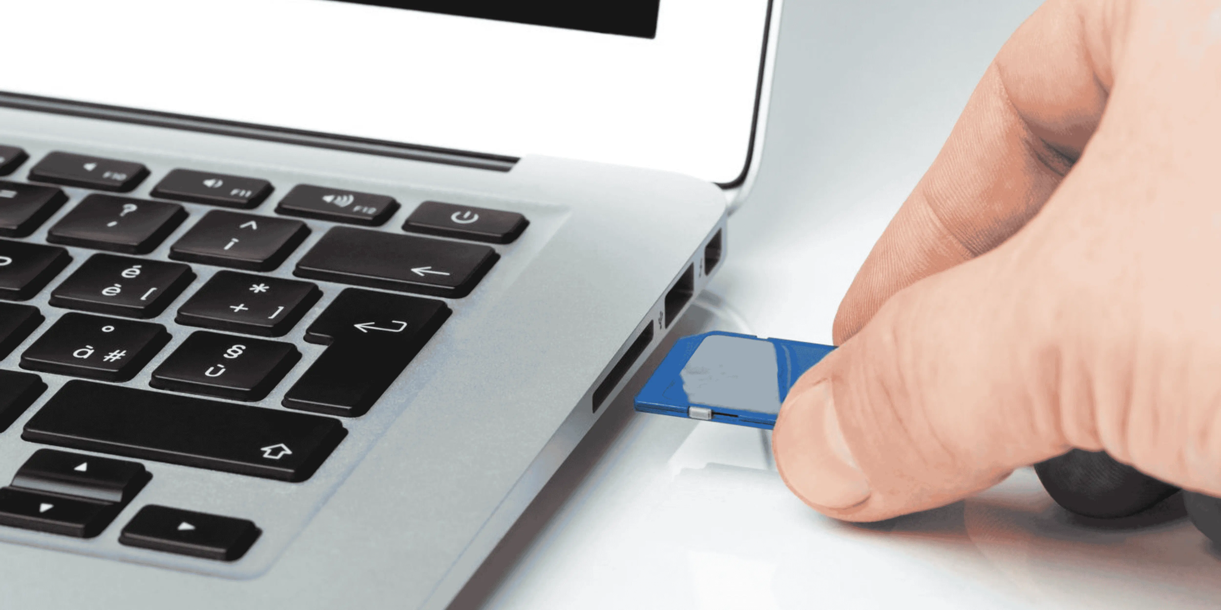 SD card being inserted into a computer card reader for CPAP data import